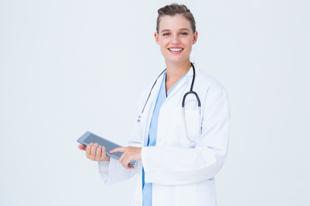 Happy doctor holding tablet pc