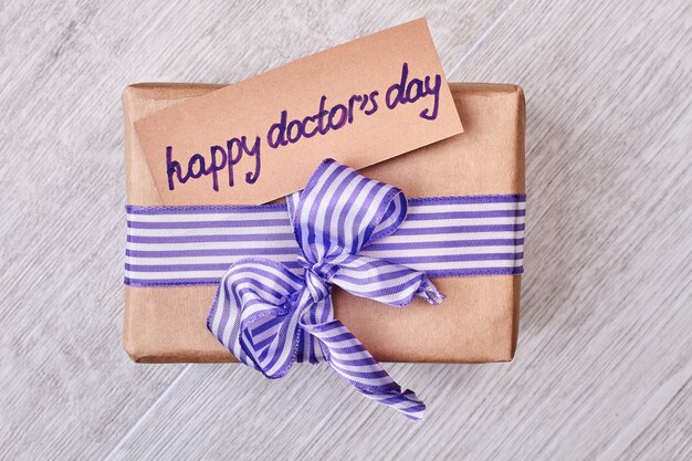 Happy Doctor's Day present box. Greeting card and bow. Congratulations for doctor.