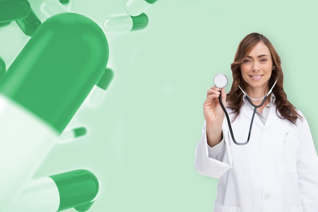 Photo happy doctor using stethoscope against green medical background with pills