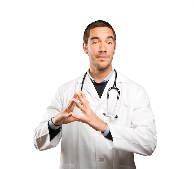 Happy doctor with a concentration gesture