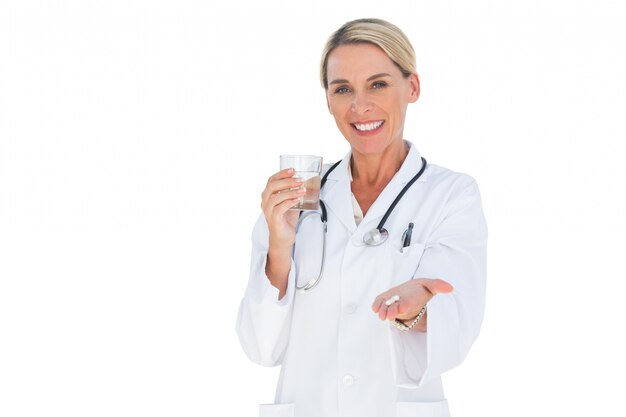 Happy doctor with pills and a glass of water in her hands