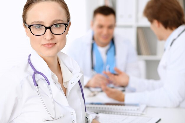 Happy doctor woman with medical staff at the hospital