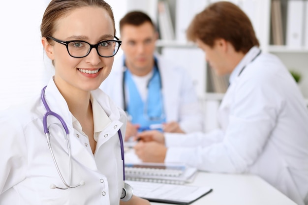 Happy doctor woman with medical staff at the hospital