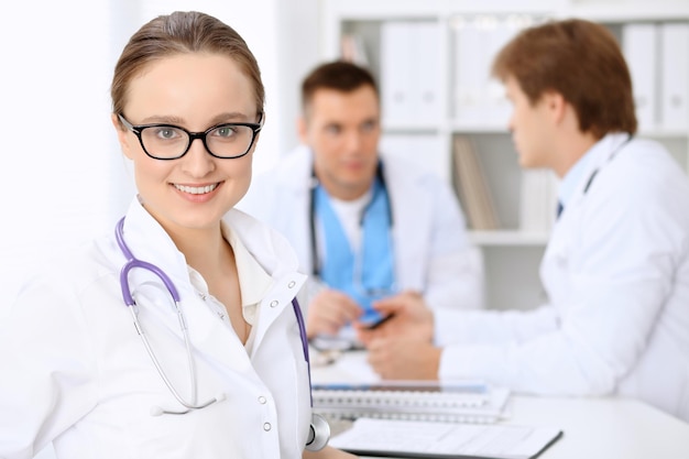 Happy doctor woman  with medical staff at the hospital