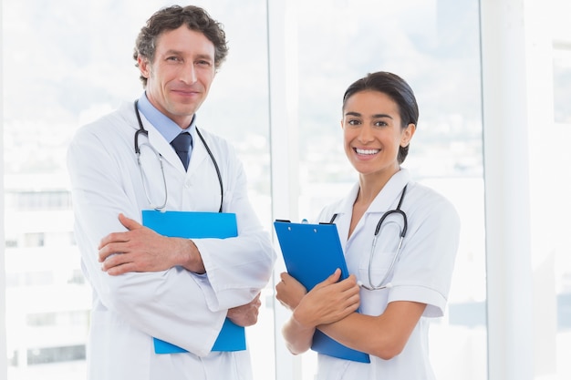 Happy doctors looking at camera 