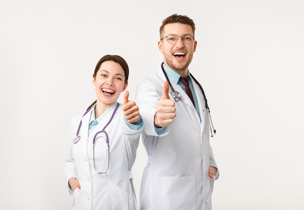 Happy doctors man and woman isolated on white