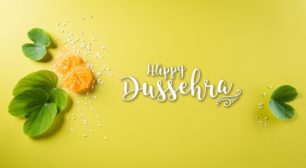 Happy Dussehra background concept. Green leaf and rice