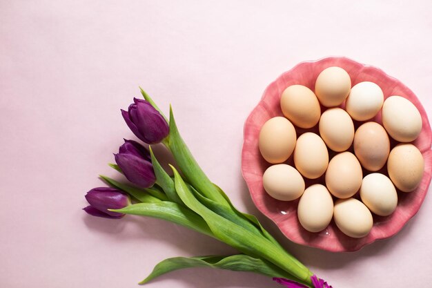 Happy Easter Background with easter eggs and purple tulips