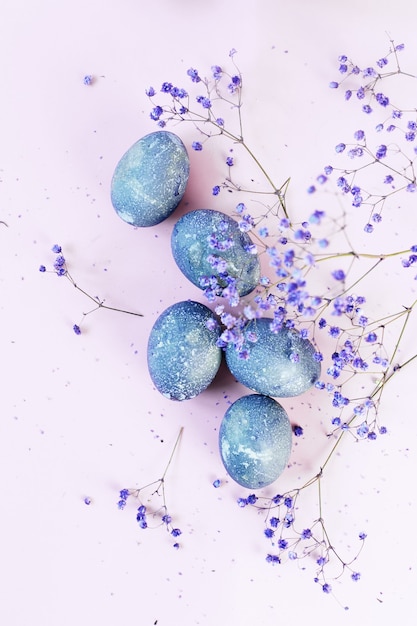 Happy Easter card with blue eggs and flowers
