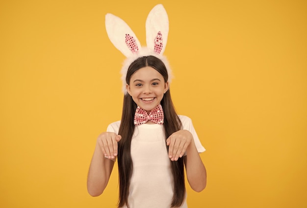 Happy easter child girl in bunny ears and bow tie happy easter