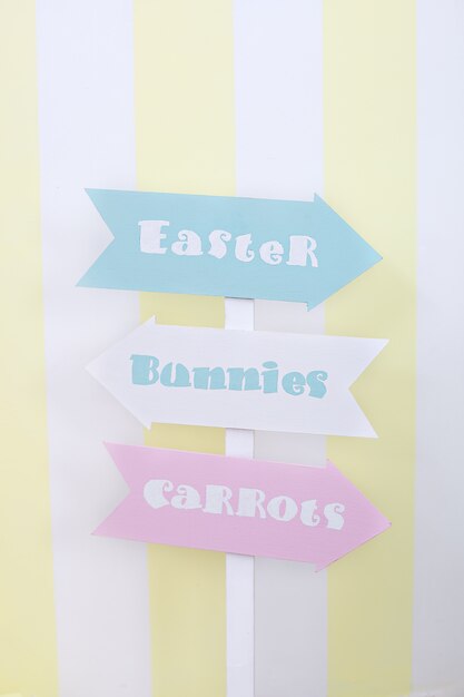 Happy easter! Colorful plate guide for Easter, carrots, rabbits. Easter room decoration and decor, children's playroom.  Easter sign pointer. Bright colored room
