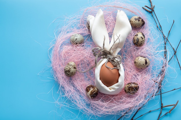 Happy Easter compositions card with eggs in nest over wood 