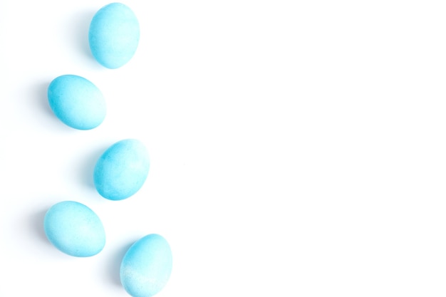 Happy Easter concept. Chicken eggs painted in blue color in the egg compartment