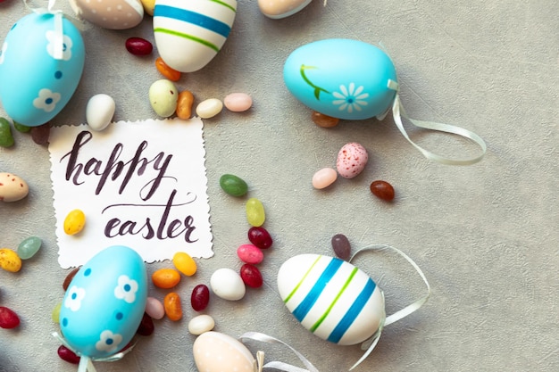 Happy easter concept preparation for holiday easter eggs inscription happy easter letters candy choc...