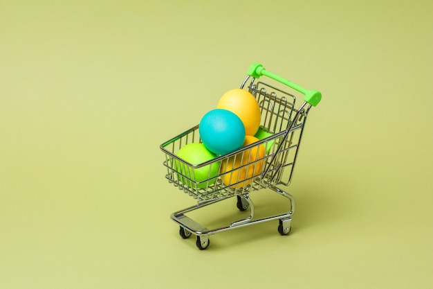 Happy Easter concept with easter eggs in supermarket trolley