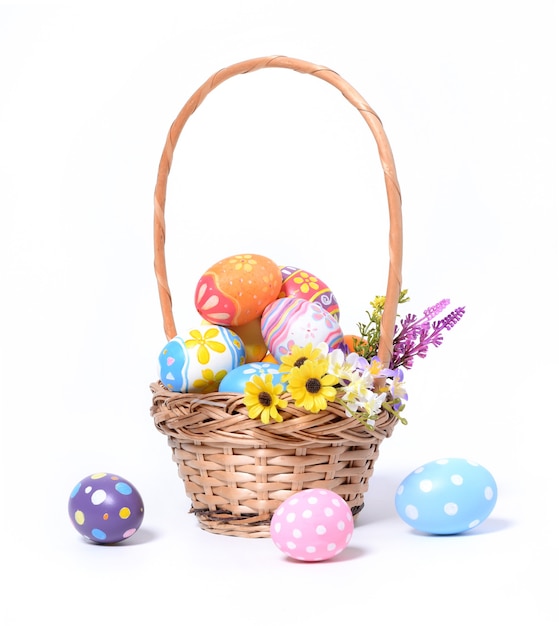 Happy Easter day colorful eggs in basket with flowers isolated on white background.