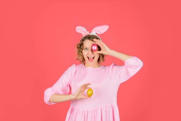 Happy easter egg hunt girl holds color egg spring holiday smiling woman in rabbit bunny ears woman