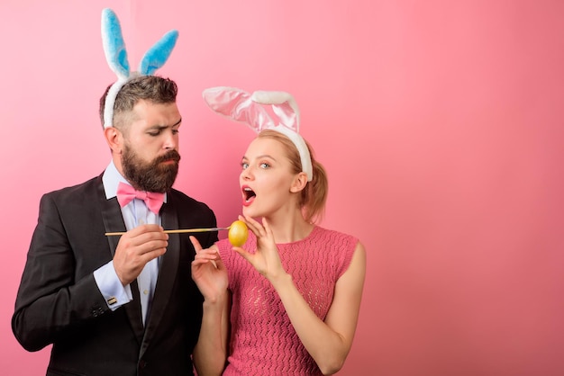 Happy Easter! Family celebrate Easter. Easter rabbits. Bunny couple. Happy holidays. Happy couple painting eggs for holidays. Decorating eggs. Spring holidays. Bunny ears. Couple with bunny ears.