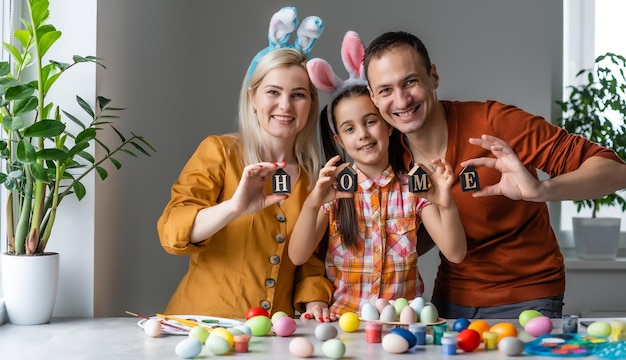 Happy easter! family mother, father and children having fun paint and decorate eggs for holiday.