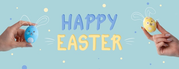 Photo happy easter greeting card holiday congratulation blue yellow color painted egg with cute bunny face