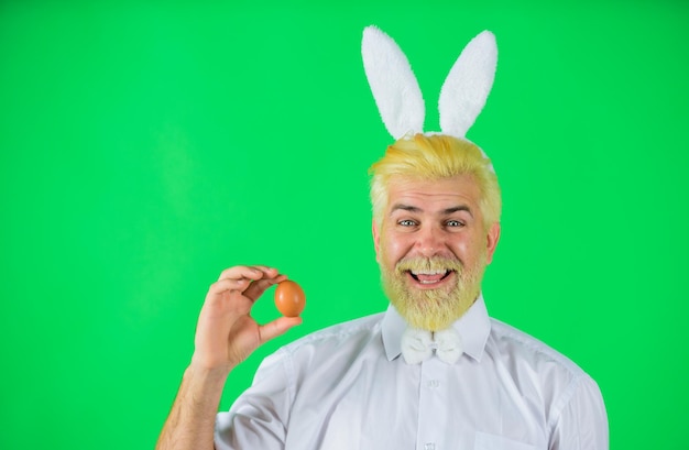 happy easter happy man with rabbit ears holds easter egg man in bunny ears holds easter egg rabbit