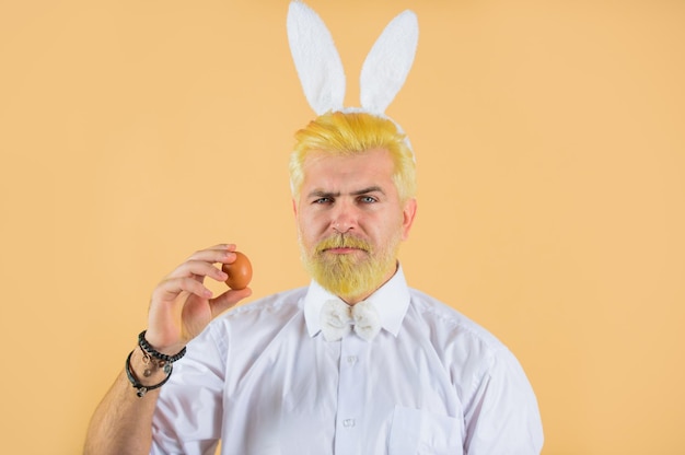 happy easter man with rabbit ears hold easter egg man in bunny ears holds easter egg rabbit man