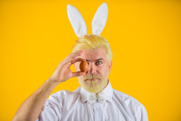 happy easter man with rabbit ears holds easter egg man in bunny ears holds easter egg rabbit man