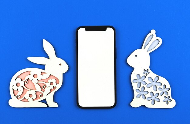 Happy Easter mockup background with place for your text, cute bunny on a blue paper, top view, flat lay photo