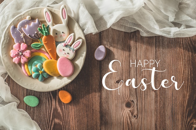 Happy Easter. Multi-colored pastel easter cookies on a wooden table. Easter concept