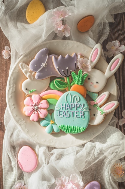 Happy Easter. Multi-colored pastel easter cookies on a wooden table. Easter concept