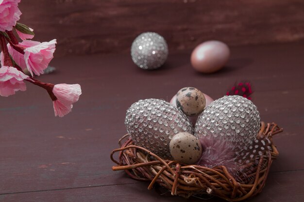 Happy Easter nest with eggs on a wooden background.