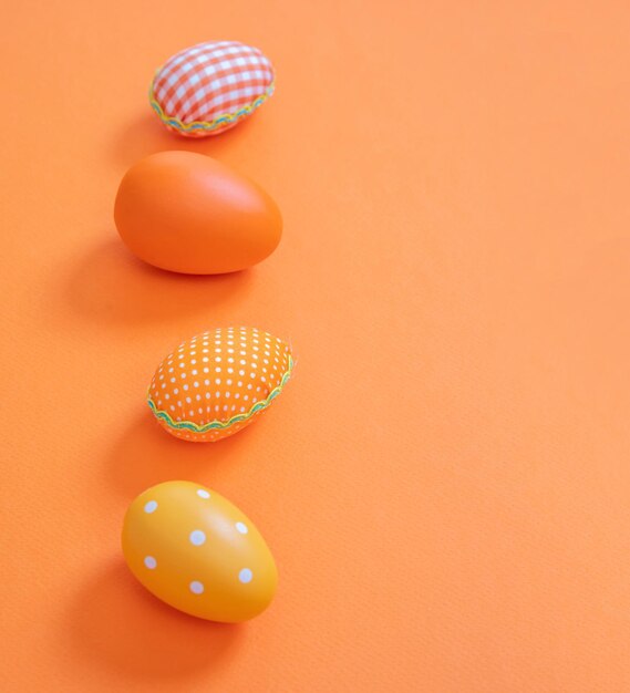 Happy Easter Orange pastel color eggs on orange background copy space
