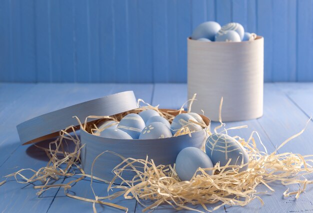 Happy easter painted eggs on wooden colorful table,. Copy space