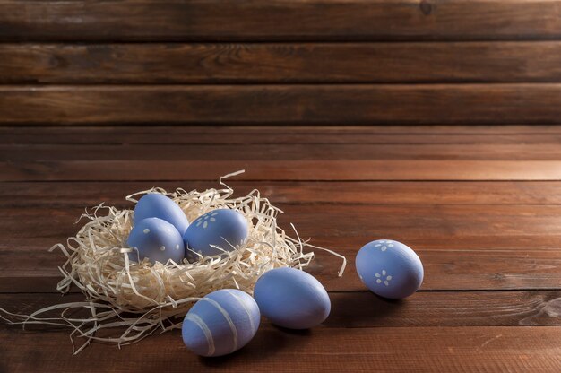 Happy easter painted eggs on wooden colorful table,. Egg hunt, copy space