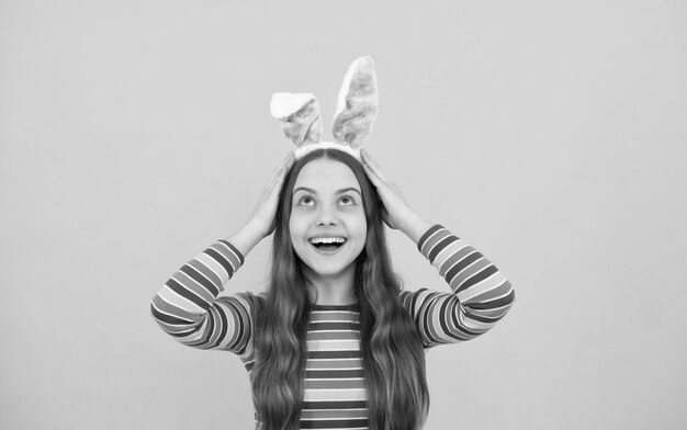 Happy easter teen girl in rabbit bunny ears smiling on holiday bunny hunt