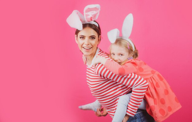 Happy easter two sisters hunting for easter eggs girls with bunny ears