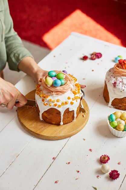 Happy Easter Woman cut Easter cake for the holiday