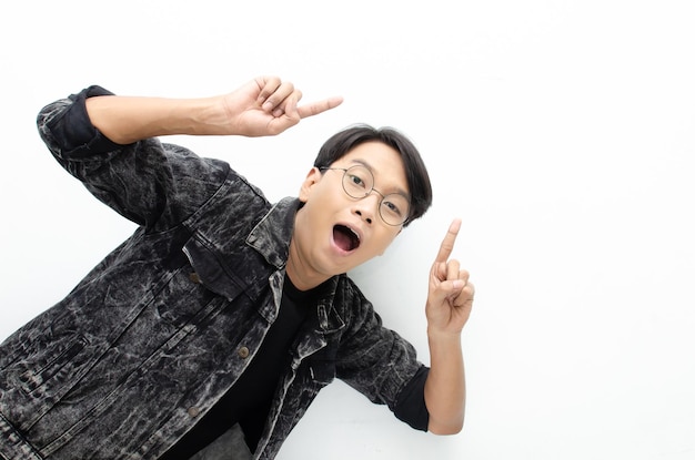 Happy Ecstatic asian man wear jacket jeans pointing finger to copy space presenting and showing.