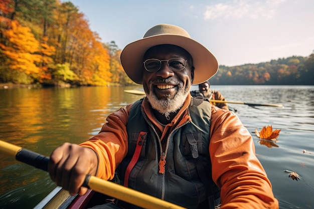 Premium Photo  Happy elderly blackskinned man in hat floating on a kayak  along an autumn river