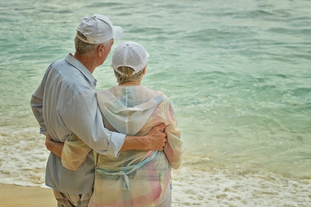 Happy elderly couple rest at tropical beach