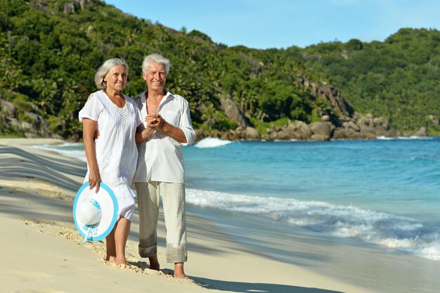 Happy elderly couple rest at tropical beach