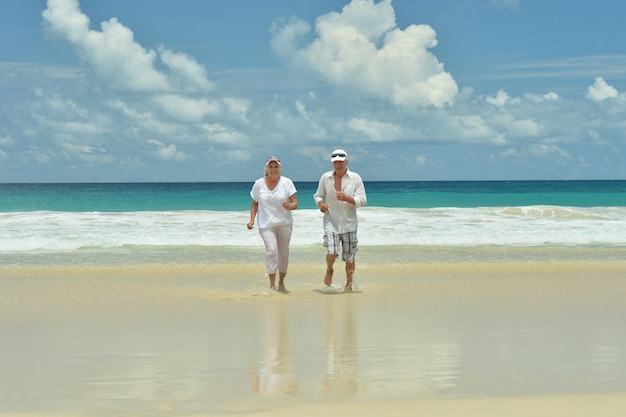 Happy elderly couple running