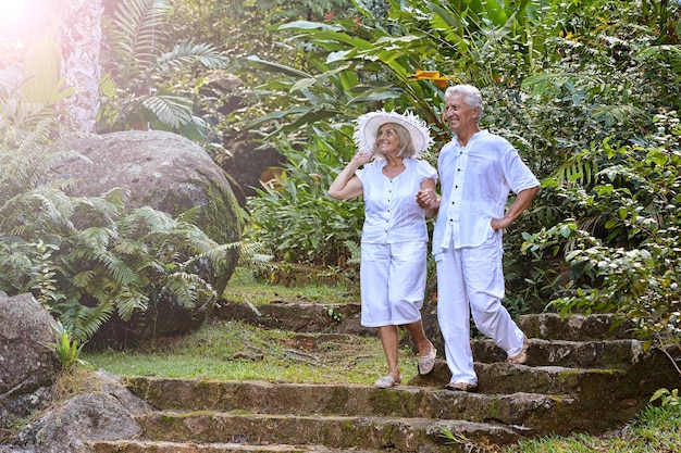 Happy elderly couple   in tropical garden outdoor