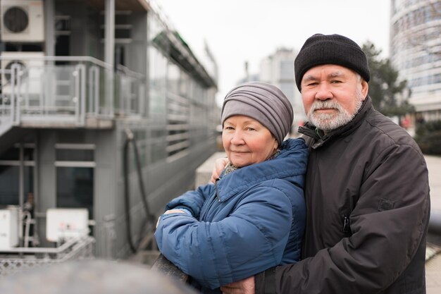 A happy elderly couple on a walk along the promenade tourism and retirement travel active and healthy old men and women