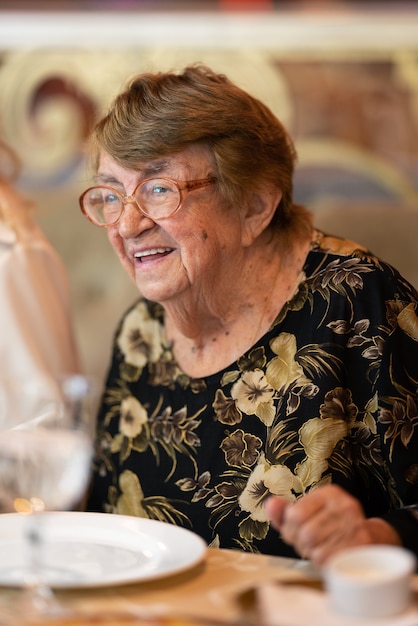 Happy elderly woman at family dinner