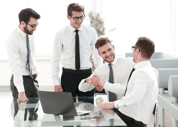 Happy employees shaking hands success concept