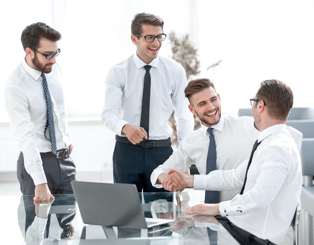 Happy employees shaking hands