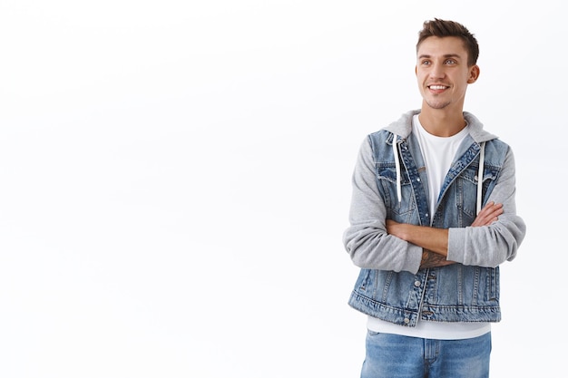 Happy enthusiastic caucasian guy cross arms chest, looking upper left corner with dreamy satisfied smile