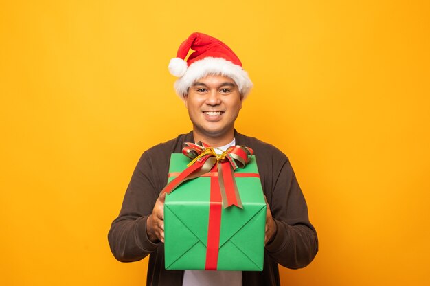 Happy excited asian man with a gift box