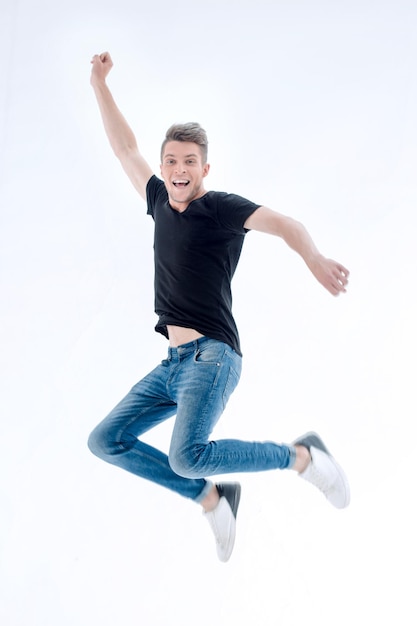 Happy excited cheerful young man jumping and celebrating success